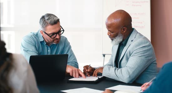 Real estate investor reviewing Truehold Financial financing documents with a lending partner